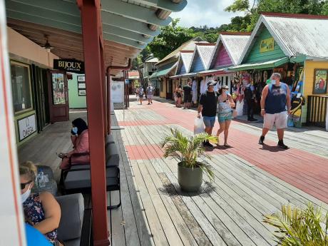 Tourists from the Carnival Sunrise cruise ship shopping at Island Village in Ocho Rios, St Ann, yesterday.