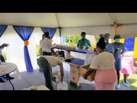 Members of staff at the Savanna-la-Mar Hospital in Westmoreland receive food items distributed by members of the Westmoreland Chamber of Commerce and Industry and the Rotary Club of Savanna-la-Mar, during both clubs’ outreach efforts to the hospital on S