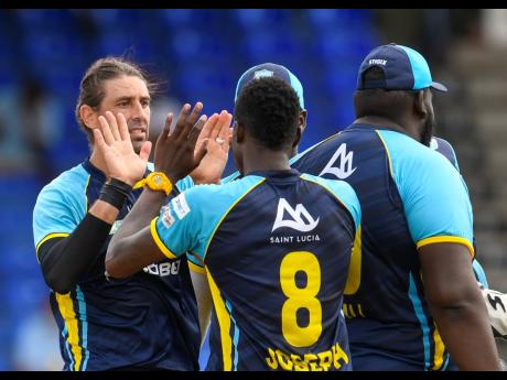 David Wiese (left) of Saint Lucia Kings celebrates the dismissal of Kieron Pollard of Trinbago Knight Riders during the 2021 Hero Caribbean Premier League Play-Off match between Saint Lucia Kings and Trinbago Knight Riders at Warner Park Sporting Complex y