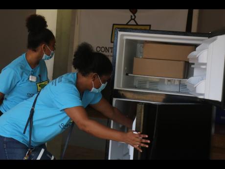 Members of the Hanover Charities team check out one of the stocked refrigerators.