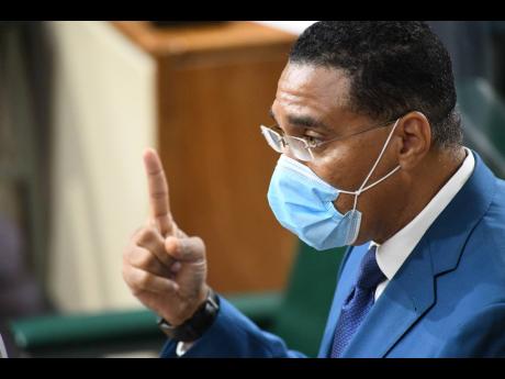 Prime Minister Andrew Holness gestures during his presentation at the sitting of the House of Representatives in Kingston on Wednesday.