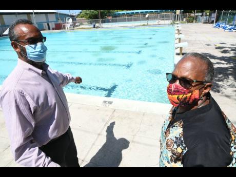 Sarah Newland Martin, administrator and general secretary of the YMCA, is seen here with Allan Marsh, chairman, beside a swimming pool on the Y’s Hope Road compound in this July 20, 2020, photograph. 