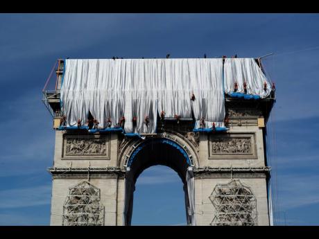Workers wrap the Arc de Triomphe monument on September 12. The ‘L’Arc de Triomphe, Wrapped’ project by late artists Christo and Jeanne-Claude will be on view from September 8 to October 3. The famed Paris monument has been wrapped in 25,000 square me
