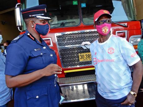 Minister of Local Government and Community Development, Desmond McKenzie (right) and Assistant Commissioner of the Jamaica Fire Brigade, Julian Davis-Buckle, in discussion at the Ocho Rios fire station Friday afternoon. 