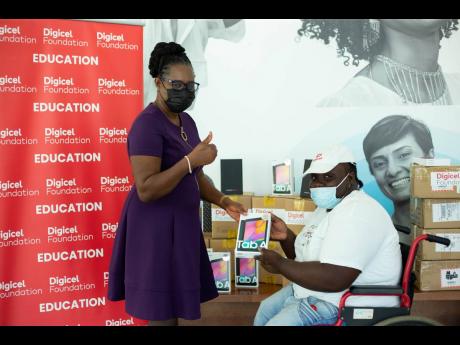 Digicel Foundation donates an additional 100 tablets to students with special needs. Jeneard Williamson, education and special needs officer, Digicel Foundation, presents Dr Christine Hendricks, executive director of the Jamaica Council for Persons with Di