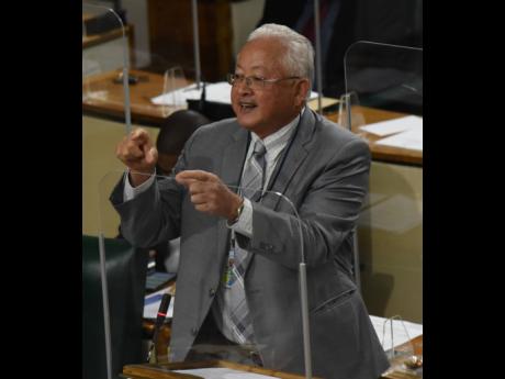 Delroy Chuck, minister of justice, addresses Parliament on Tuesday.