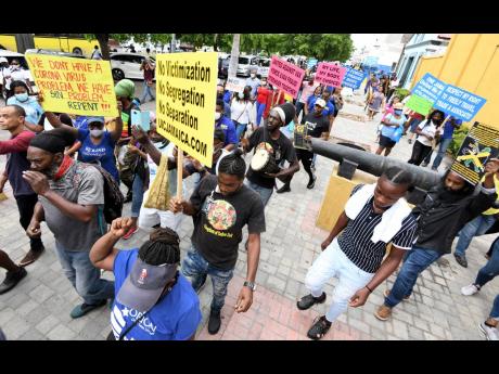 Protesters proceed on their march from North Parade in downtown Kingston towards Gordon House in defiance of instructions from the police not to proceed with the unauthorised event.