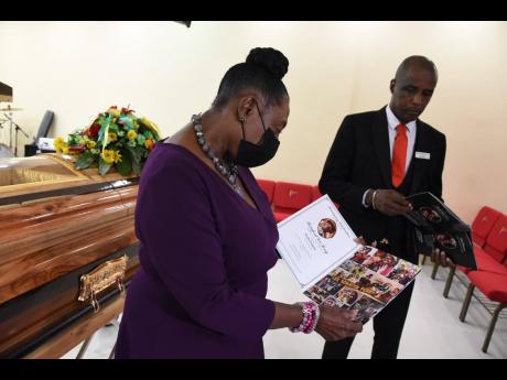 Peter Perry (right), chief executive officer of Perry's Funeral Home and Olivia 'Babsy' Grange, Minister of Culture, Gender, Entertainment and Sport, at the viewing for late musical icon Lee 'Scratch' Perry held at the Spanish Town, St Catherine funeral ho