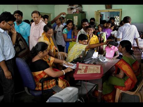 In this Wednesday, May 16, 2012 file photo, Indians crowd a room as they wait to enrol for Aadhar, India's unique identification project in Kolkata, India. A US-based private cybersecurity company said on Wednesday, September 22, it has uncovered evidence 