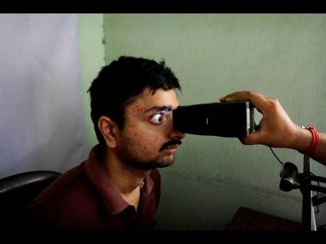 In this May 16, 2012 file photo, an Indian man gets his retina scanned to register for Aadhar, India's unique identification project, in Kolkata, India. A US-based private cybersecurity company said on Wednesday, September 22, it has uncovered evidence tha