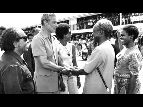 
A firm and warm handshake between Prime Minister Michael Manley and Tanzanian President Julius K. Nyerere as final farewells are made at Sangster International Airport in Montego Bay on September 18, 1974. At left is Senator Dudley Thompson and at right M