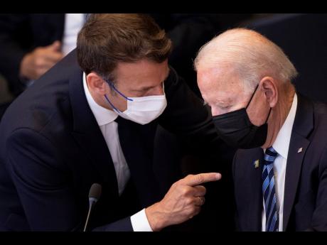 AP
In this June 14 file photo, US President Joe Biden, right, speaks with French President Emmanuel Macron during a plenary session at a NATO summit at NATO headquarters in Brussels. 