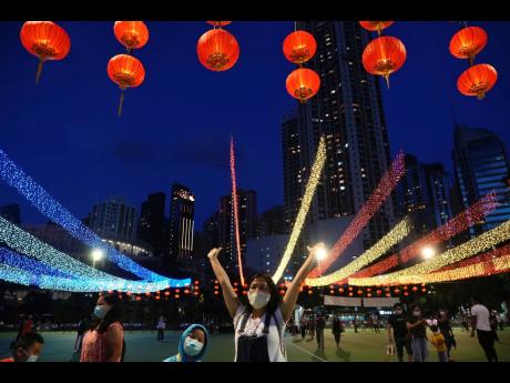 People take photos with decorations during the Mid-Autumn Festival at Victoria Park in Hong Kong
