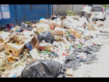 Uncollected garbage piled up at Manchester Street, Spanish Town. 