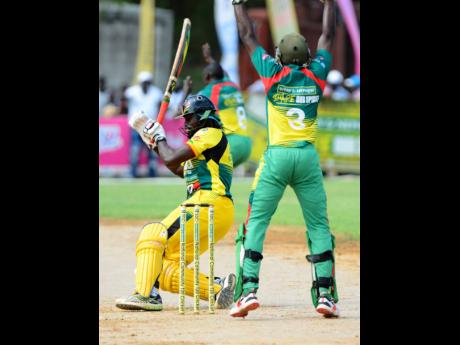 
Myron Wilson (left) from Orange Hill, falls to the ground as he was trapped LBW in the SDC Community T20 cricket final against Gayle. The final was played at the Naranda Sports Complex in Discovery Bay, St Ann, on Sunday, August 25, 2019.