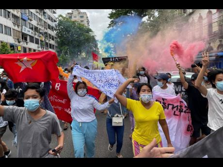 In this July 7 file photo, students protest against the February military takeover by the State Administration Council as they march at Kyauktada township in Yangon, Myanmar. 