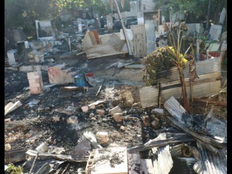 The scorched wreckage of three houses that were destroyed by arsonists at Gordon Crescent in Granville, St James, on Sunday morning.