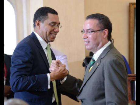 Prime Minister Andrew Holness (left) congratulates Daryl Vaz at a swearing-in ceremony of Cabinet ministers and ministers of state at King’s House on Monday, March 7, 2016. Holness is under pressure to address the latest twist in the Daryl Vaz visa saga.