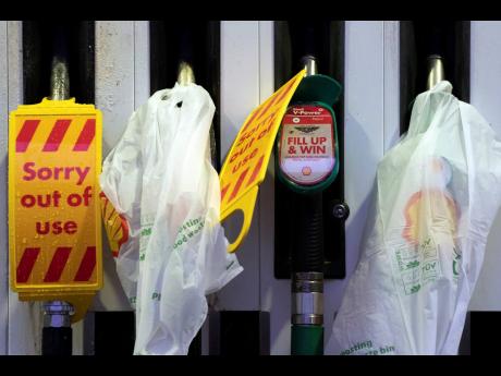 Closed pumps are seen on the forecourt of a petrol station in Manchester, England, on Monday, September 27. The petrol station was one of many across the UK which ran out of fuel after an outbreak of panic buying. AP