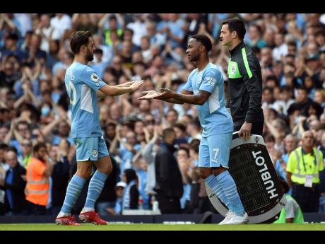 Manchester City's Raheem Sterling (right) comes on, replacing Bernardo Silva. during the English Premier League match against Arsenal at Etihad stadium in Manchester, England, on Saturday, August 28.