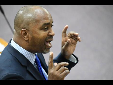 St Andrew South East Member of Parliament Julian Robinson addresses lawmakers on Tuesday about blackouts in communities in his constituency. He has called on the Government and watchdog the Office of Utilities Regulation to crack down on the practice. 