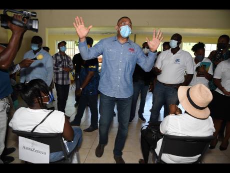 Ian Allen/Photographer 
Prime Minister Andrew Holness talking to residents and health officials at the St Mary Parish Church during a vaccination blitz in Port Maria, St Mary on Thursday. 
