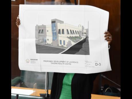 Juliet Cuthbert-Flynn, member of parliament for St Andrew West Rural, displays a diagram of what the new Lawrence Tavern Health Centre will look like. She was making her contribution to the 2021 State of the Constituency Debate on Tuesday.