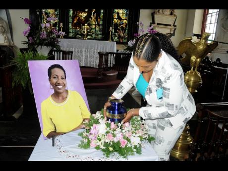 Jhanine Jackson places the urn with Karen Smith’s ashes after she was cremated.