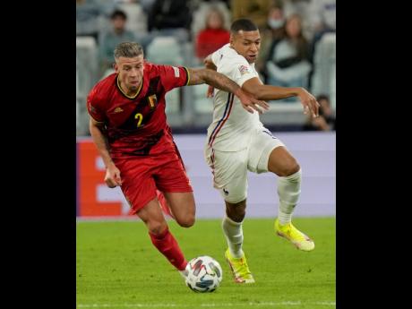 Belgium’s Toby Alderweireld (left) challenges France’s Kylian Mbappe during the UEFA Nations League semi-final match at the Juventus stadium in Turin, Italy, yesterday. France won 3-2.