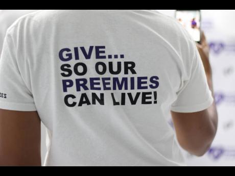The back of the Preemie Foundation shirt encourages volunteers to donate. 