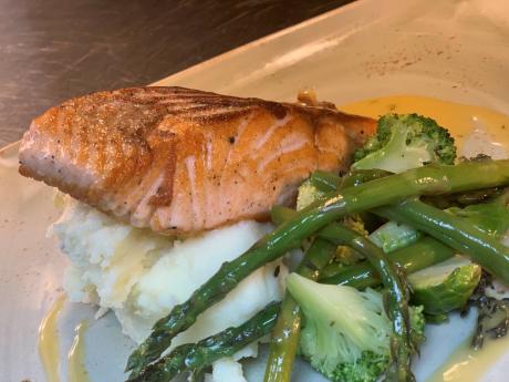 Honey and lemon brush seared salmon fillet dill beurre blanc, topped with toasted almonds and lemon.