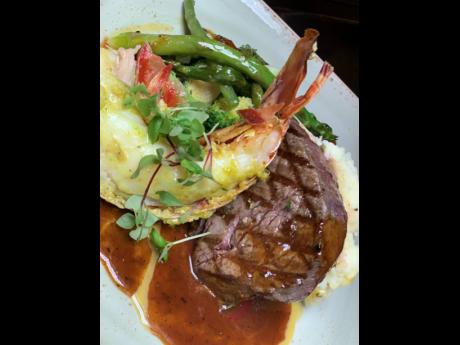 Classic Caribbean surf and turf Dijon and herb crusted beef tenderloin and pimento grilled lobster tail, served in a red wine reduction and garlic butter sauce.
