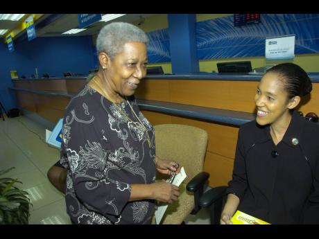 Veteran journalist and communicator Carmen Tipling (left), shares a light moment with the current chief executive officer of the  Jamaica Information Service, Donna-Marie Rowe.