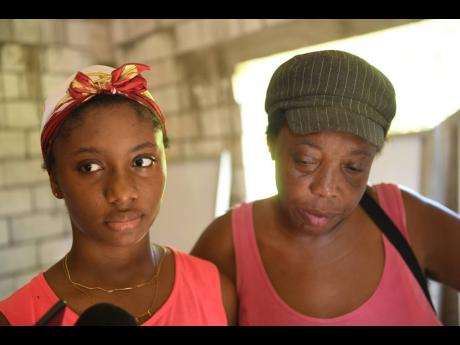 Tiana Cooke, sister of Winshae Barrett, talks to journalists in the presence of her aunt, Paula Douglas, on Sunday.