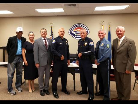 Actor Morgan Freeman (left), with six other members of a panel that interviewed police recruits in Gulf Shores, Alabama, on Friday. 