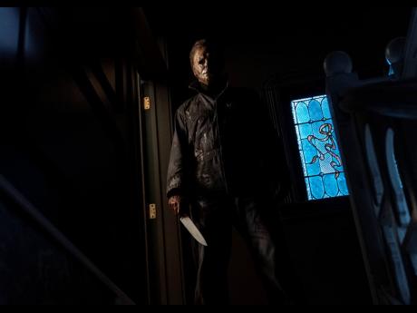 Top: Serial killer Michael Myers returns in the ‘Halloween’ sequel, ‘Halloween Kills’. 