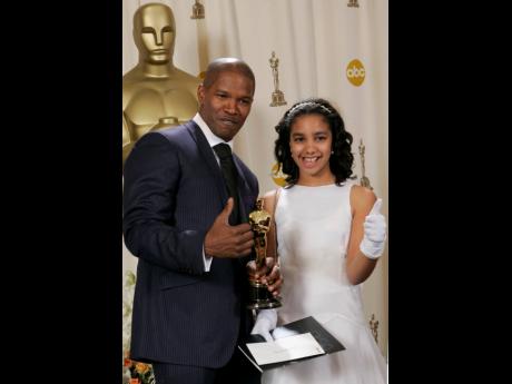 Jamie Foxx poses with his daughter Corinne and the Oscar he won in 2005 for Best Actor for his work in ‘Ray’.