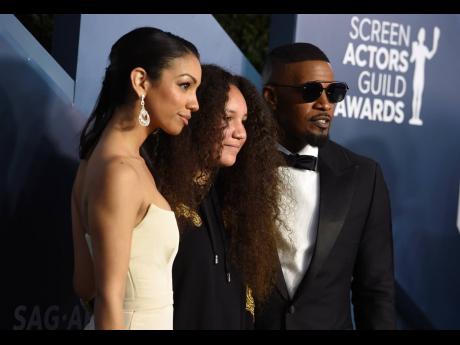 Actor-singer Jamie Foxx (right), poses with his daughters Corinne Foxx (left), and Anelise Bishop.