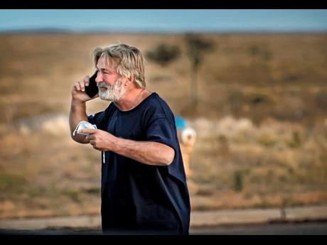 Alec Baldwin speaks on the phone in the parking lot outside the Santa Fe County Sheriff's Office in Santa Fe, New Mexico, after he was questioned about a shooting on the set of the film 'Rust' on the outskirts of Santa Fe on Thursday. Baldwin fired a prop 