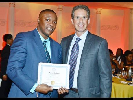 Daren Johnson with Marc Jerome, president of Monroe College, where he picked up awards for making the President’s List and summa cum laude honours. 