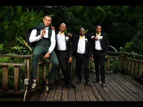 From left: The groom, Demar Lyle, stands with best man Gregory Tomlinson and groomsmen, his cousin and lifelong friend Javis Lyle and brother-in-law Allen ‘Andy’ Robinson.