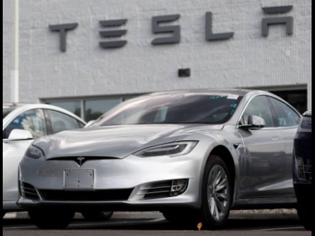 This file photo shows Tesla 2018 Model 3 sedans.