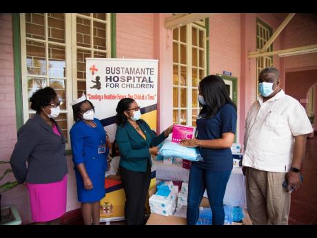 Senior Medical Officer at the Bustamante Hospital for Children, Dr Michelle-Ann Richards-Dawson (third left), receives medical items from Country Representative, Diaspora for Children Foundation, Kimberly Nain (second right). Occasion was a recent handover