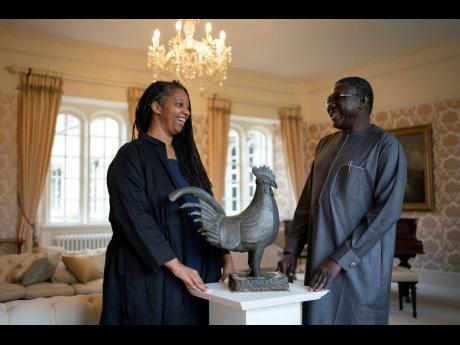 Master of Jesus College, Sonita Alleyne, and Director General of Nigeria’s National Commission for Museums and Monuments Professor Abba Isa Tijani pose for a photo ahead of a ceremony at Jesus College Cambridge, where the looted bronze cockerel, known as