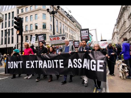 Julian Assange’s partner Stella Moris (fourth left), and Wikileaks editor-in-chief, Kristin Hrafnsson (fifth left), with supporters of WikiLeaks founder Julian Assange hold placards and take part in a march in London on Saturday ahead of this week’s ex