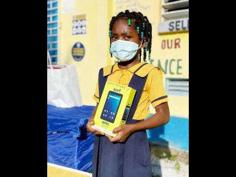 Ayesha Brown of Epsom Primary in St Catherine  shows off her brand new tablet. 