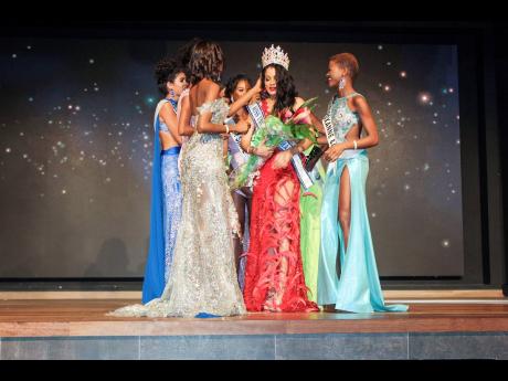 The finalists showing the new Miss Universe Jamaica 2021 Daena Soares their love and support as she tries to hold back the tears.