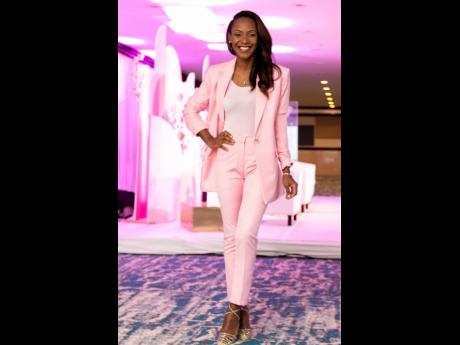 Sagicor Life Corporate Circle Branch Manager Meila McKitty Plummer strikes a pose in her pink pantsuit.