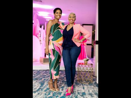 Beautifully adorned and in keeping with the pink-themed event, Chelan Smith (left), lifestyle blogger, social media specialist and breast cancer survivor, and host, Debbie Bissoon. 