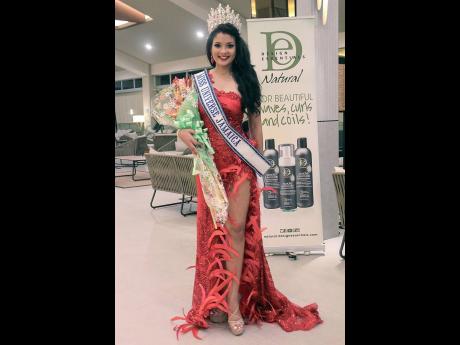 Miss Universe Jamaica 2021 Daena Soares is a vision in this red Dermoth Williams Couture gown. 